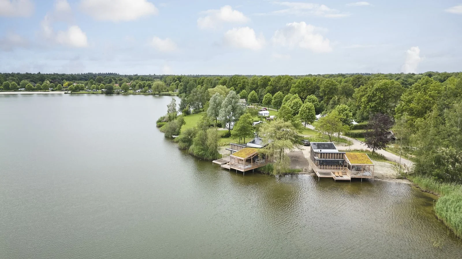 Foto gemaakt met een drone: een overzicht uit de lucht van Recreatiepark TerSpegel gelegen aan een plas.